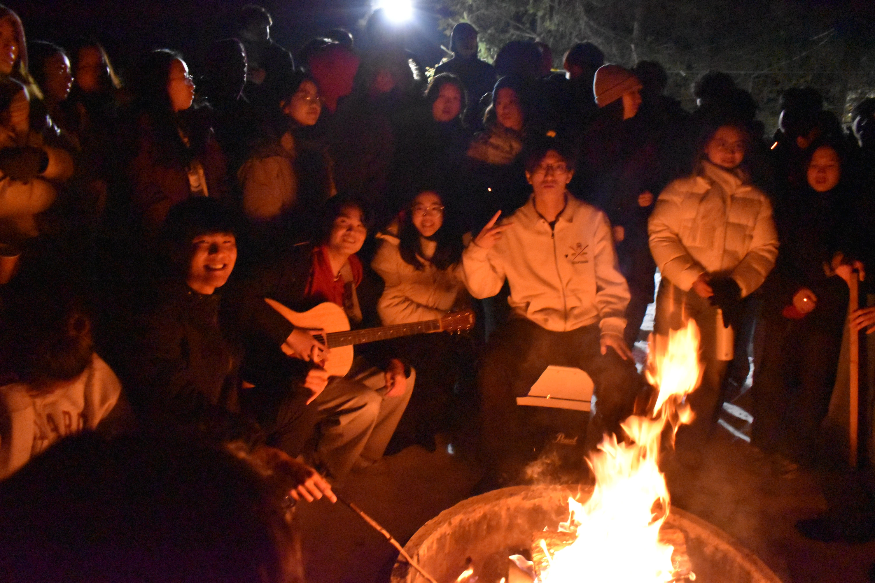 CCF members singing together around a campfire